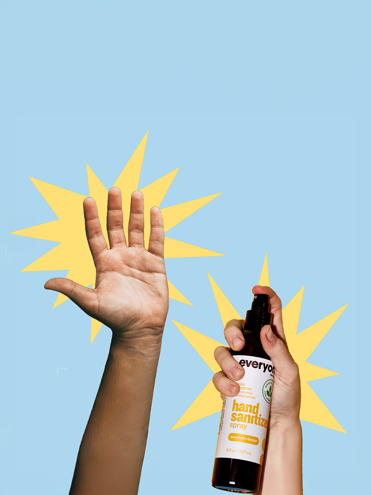 A hand sanitizer spray bottle being held over a raised hand against a light blue background with yellow starburst graphics.